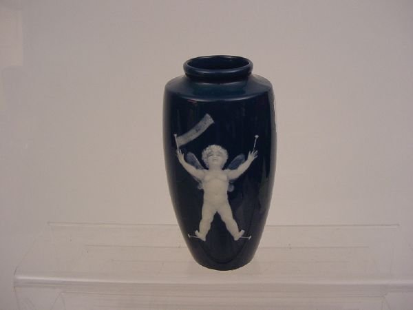 A Minton pottery deep blue ground baluster vase wi: A Minton pottery deep blue ground baluster vase with a pate-sur-pate angelic figurine holding a banner with the name 'Common Butterfly', unattrib- uted artist, 5.75 ins high (ILLUSTRATED)