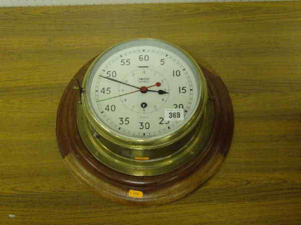 A Smiths Astral twenty four hour maritime clock w: A Smiths Astral twenty four hour maritime clock with circular dial, glass case and wooden base