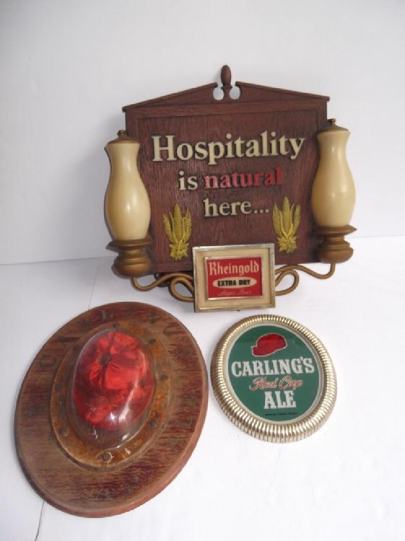 3 beer advertising display signs: 3 beer advertising display signs including Rheingold lighted sign; Carling's red cap wood plaque with red cap inside; Carling's red cap ale glass sign. Wear; faded. Largest measures 15 inches x 15 1/2
