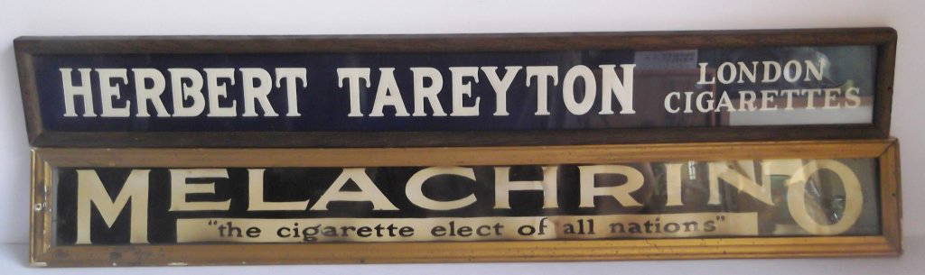 2 framed cardboard cigarette store displays: 2 framed cardboard cigarette store displays, including Herbert Tareyton London Cigarettes & Melachrino the cigarette elect of all nations. Stained. 28 inches wide x 4 inches high.