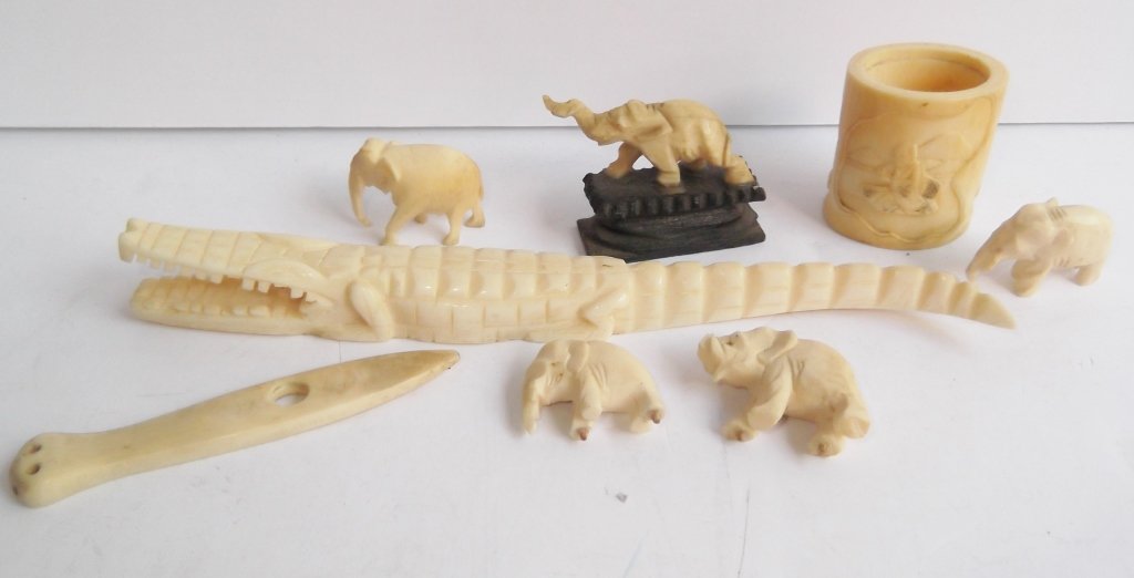 8 assorted carved bone pieces: 8 assorted carved bone pieces including alligator; elephants; napkin ring. Repair to alligator. Largest measures 7 inches long.