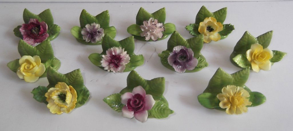 Coalport place setting floral card holders: Set of 11 porcelain Coalport place setting floral card holders. Chips to some flowers. 2 inches x 1 inch.