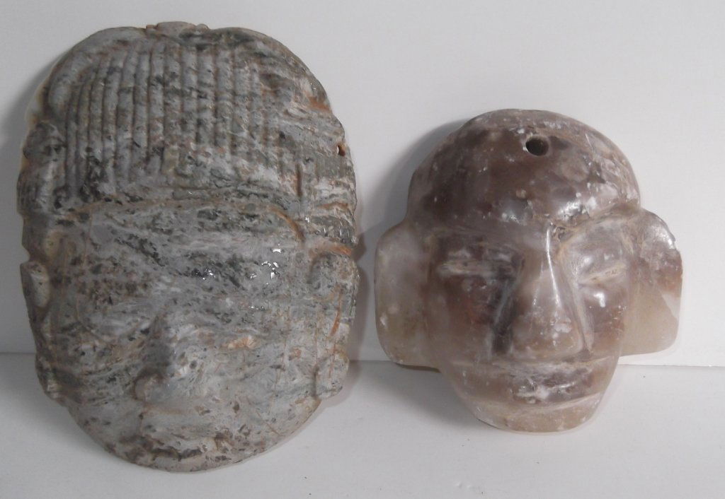 2 carved stone face sculptures (1 of 3)