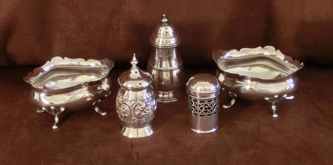 Collection of 5 English Sterling Silver Condiments: All Birmingham - A pair of oval Edwardian salts on 4 feet, 1916, Levi and Salaman, 3 1/8" x 2 1/4"; Repousse shaker, 1897, maker JM, 2 1/2" H; Pierced cylindrical shaker with cobalt blue liner, 1922, 