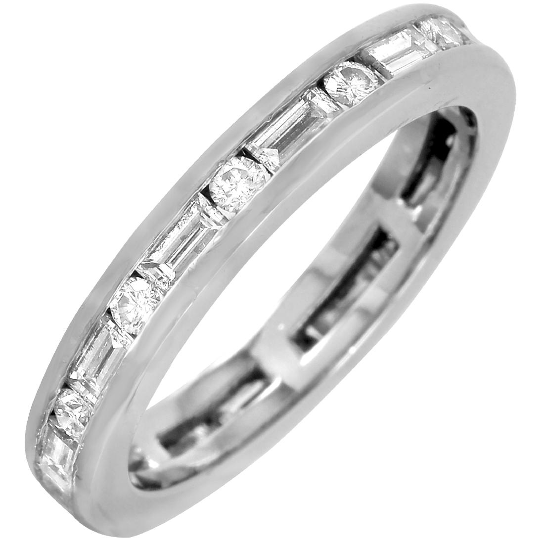 Platinum Diamond Eternity Band: Platinum eternity wedding band featuring alternating round brilliant cut and baguette cut diamonds in a channel setting. Classic in style, this band can be worn alone, or easily paired up with a varie