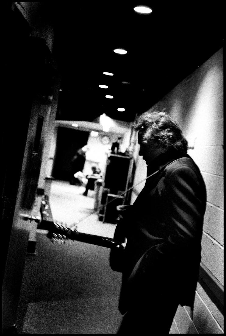 Johnny Cash Waiting in a Hallway: Johnny Cash Waiting in a Hallway. Great Photo from Danny Clinch's Famous Collection of Images Shot During the Grammy's. nnDanny Clinch loves music. He listens to it, plays it, photographs it, and film