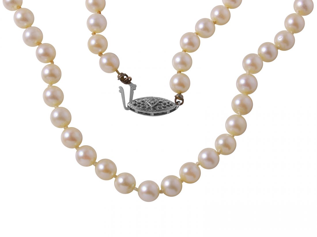 14KT White Gold Diamond and Pearl Necklace: One uniform single strand pearl necklace 14.0" choker length, knotted with a 14KT white gold filigree clasp, containing 56 cultured pearls, 6.0mm in size to 6.1mm in size, very good uniformity, gold l