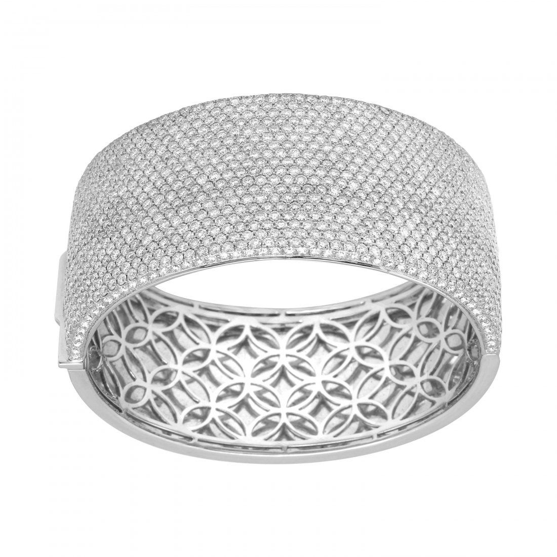 14KT White Gold Pave Diamond Bangle: Crafted in brightly polished 14KT white gold, this bangle bracelet is encrusted with round brilliant cut pave set diamonds, and closes with hidden clasp, snapping shut securely when placed on the wris