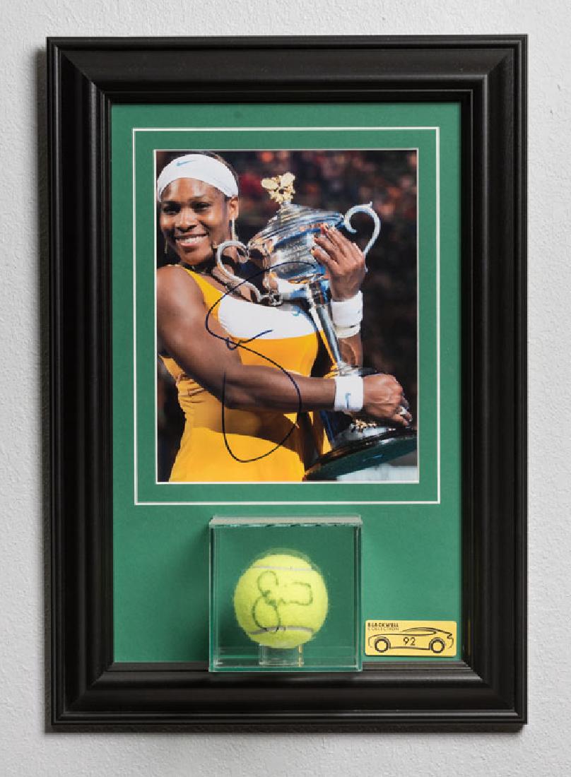 Serena Williams Signed Photo and Tennis Ball: A photograph and tennis ball, both signed by the incredible Serena Williams, perhaps the greatest athlete of our time. The stuff of tennis legend. Photograph is framed with tennis ball in separate cas