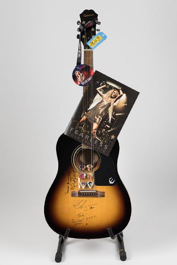 Taylor Swift Signed Guitar (4): This Epiphone acoustic instrument in sunburst pattern comes from the Taylor Swift 2009 tour and was signed by Taylor along with Jack Ingram. Comes with six Taylor Swift guitar picks, and a lanyard and