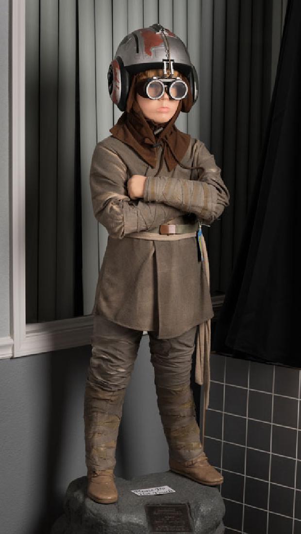 Anakin Skywalker Statue: Movie theater prop for Star Wars Episode I. Signed by Michelle Sanders, a noted fashionista involved with costume design.