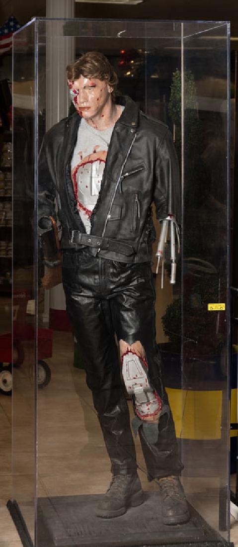 Arnold Schwarzenegger Life-Size Statue: Statue of Arnold Schwarzenegger as seen in the "Terminator" movie. Approximately 6 feet tall.**Case shown in photo is not part of this lot and may be purchased for $2,000**. Includes Certificate of Au