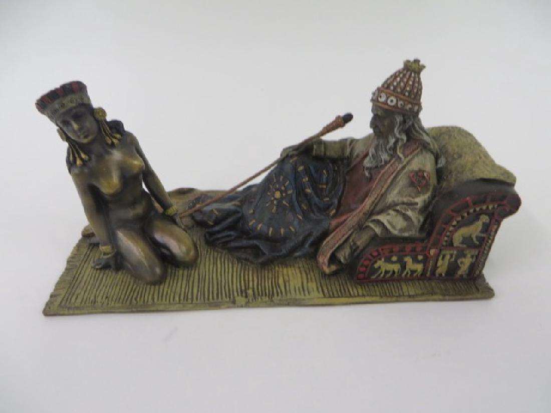 Vienna Bronze. Polychromed.: Man on a" tapestried chair", on rug with nude woman. 3" x 7"