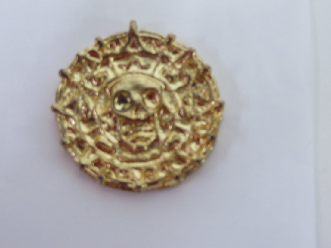 Film Prop. Pirates of the Caribbean Coin: Gold plated treasure coin. With letter C. Bailey dated 9/28/14