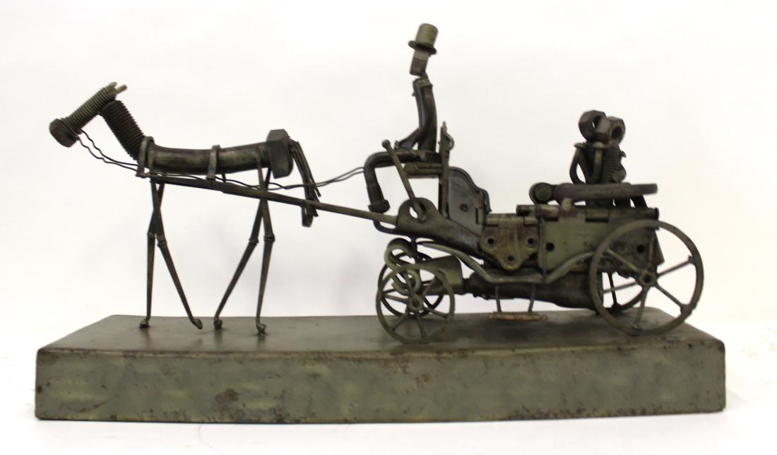 Sculpture. "Central Park" Sgd. McCabe '86: Metal nuts and bolts sculpture. "Central Park". Depicts classical horse drawn carriage with driver in top hat. Signed McCabe and date '86. 20"L. x 6"D. x 12"H.Ê