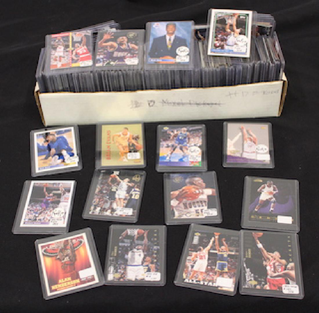 1990's NBA Card Collection (270): In protected cases . Approx. 270 cards in the lot. Companies represented are Topps, Fleer, Upper Deck, Pinnacle, Classic Games Inc and Leaf. Excellent to good condition