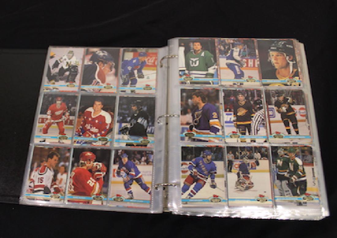 Binder of Mixed Sports & Disney Cards. (850): Stadium Club Hockey Cards 1991, approx. 396 including a Wayne Gretsky card and Topps Stadium club cards; Disney cards, approx. 207 in the lot, Disney Stories card set; Disney family portrait card set;