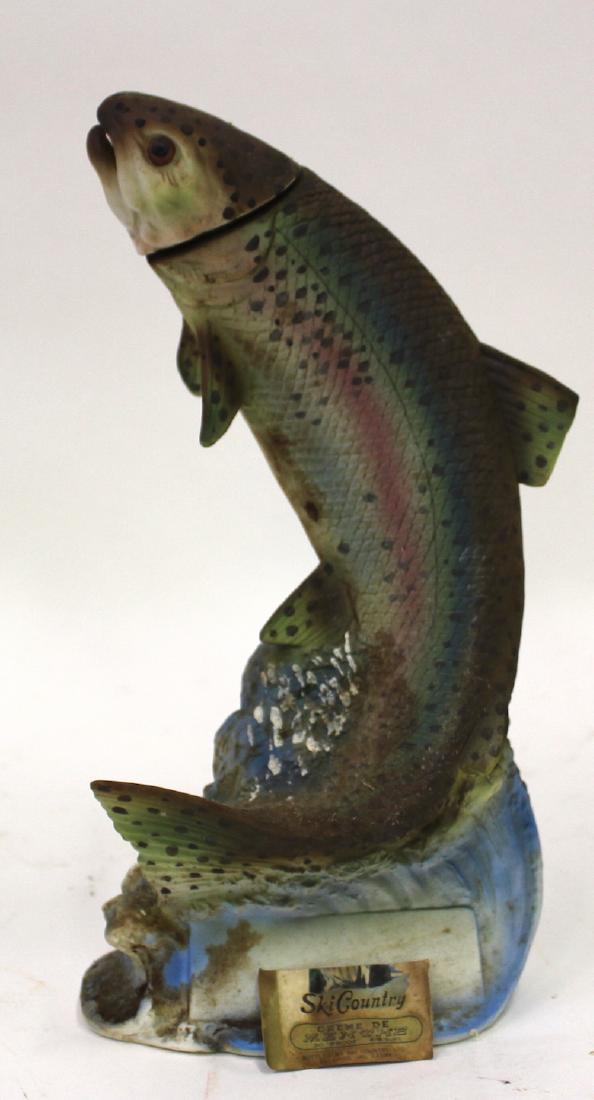 Ski Country Trout Decanter: Unopened Ski Country Crme de Menthe 30 Proof 4/5 decanter of a trout. Label has fallen off but is still with the bottle.(very worn) Bottom of bottle reads "Ski Country 4/5 The Trout 1976. Golden, Colo