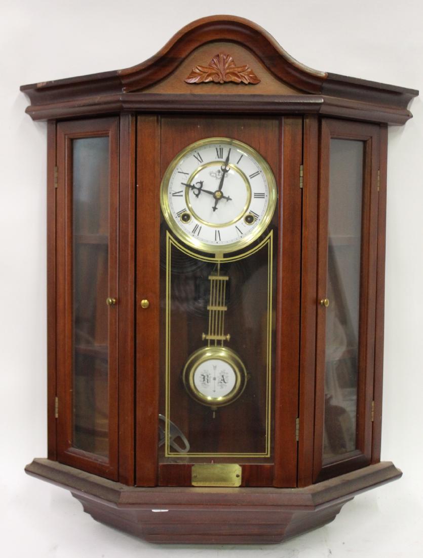 Mahogany Wall Clock: With side doors opening to reveal interior shelves . Time and Strike. 26.5"H. x 21"W. x 7.5"D