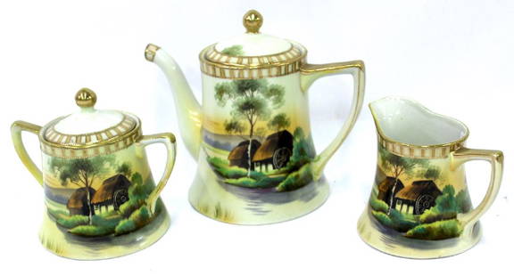 Nippon Tea Set . Signed. 3 pc.: Comprised of a teapot, creamer and a sugar with scenic decorations and marked Hand Painted Nippon at the bottom 3 1/2"H (creamer and sugar) and 7"H (teapot)