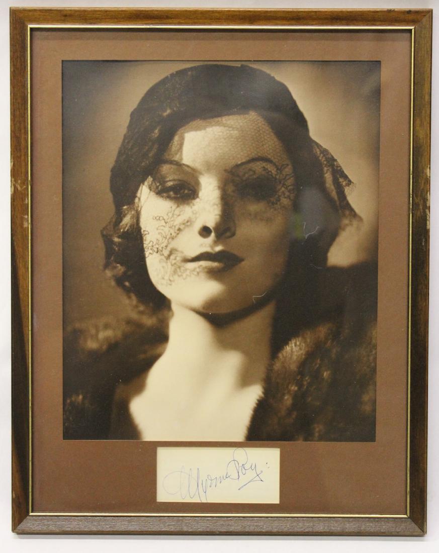 Autographed Photograph. Myrna Loy: Cut Signature in ink Myrna Loy. Framed with a superb glamour photo of the star.10 1/2"H. x 9"