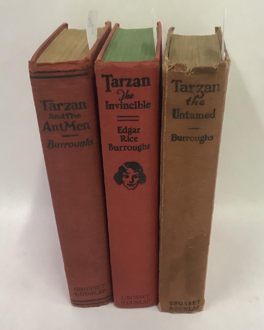 Edgar Rice Burroughs Tarzan Boks (3): The Untamed, Grosset and Dunlap, NY, 1920; The Invincible, same pub., same city, 1930-31 and Tarzan and the Antman, same pub., same city, 1924. Three books in the lot