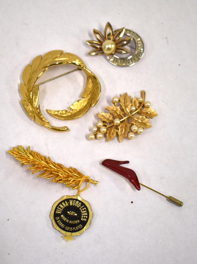 Dealer's Lot of Costume Jewelry inc. Ferragamo: Ferragamo enameled high heel shoe stick pin, sgd. together with vintage brooches (4) which include one sgd. Pennin, one sgd. Trifari and one sgd. Monet Five items in the lot.