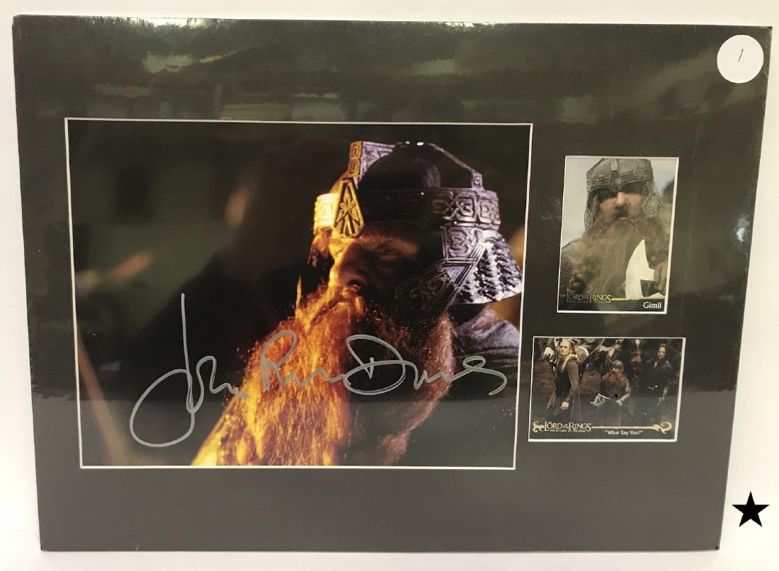 Signed John Rhys Davies Photograph.: Signed in silver ink John Rhys Davies who portrayed Gimli in The Lord of the Rings, The Return of the King. Matted with two cards from the series. Shrink wrapped for preservation. 8" x 10"