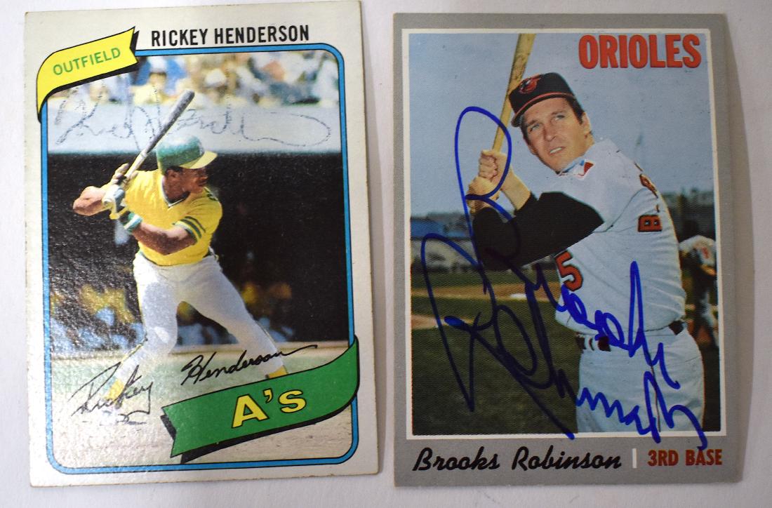 Brooks Robinson Rickey Henderson Autographs: 1970/1980 Topps trading cards for each autographed in ink. Two in the lot.