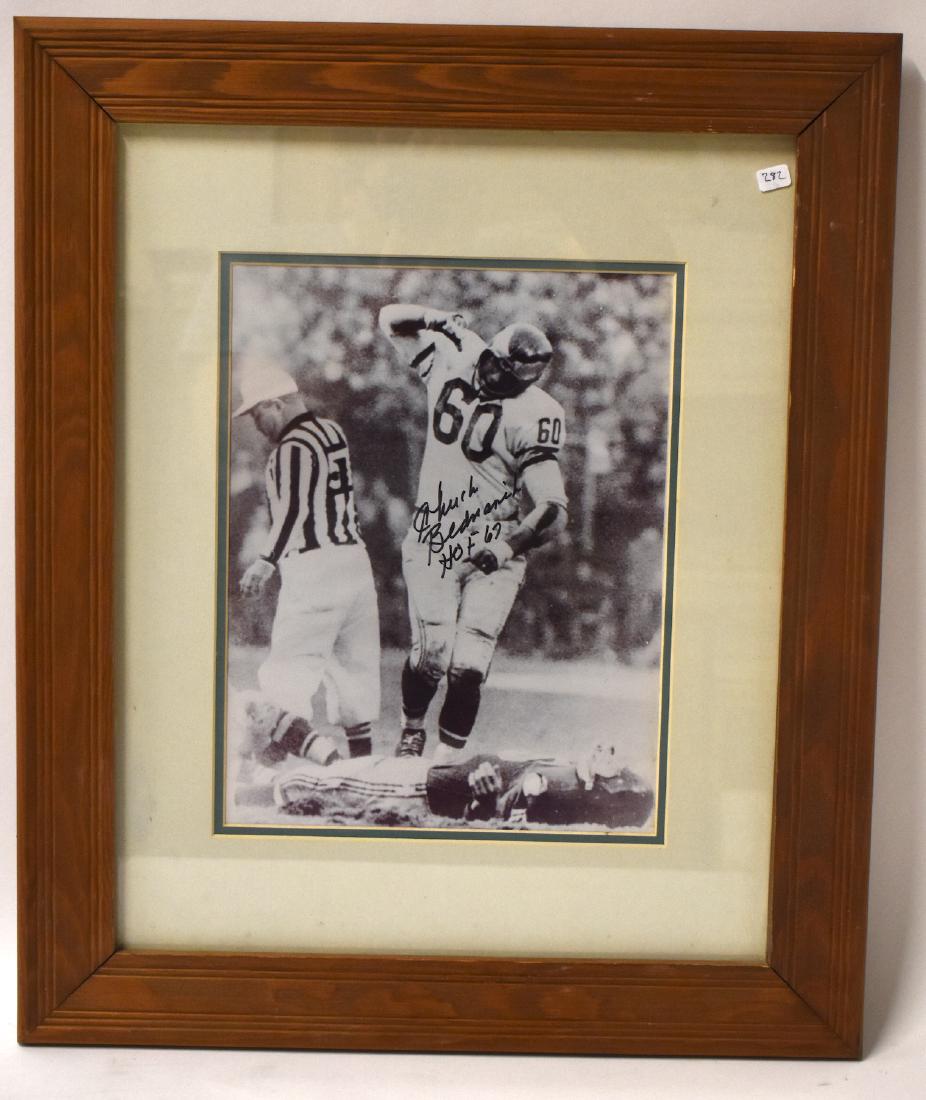 Classic Sports Photo Bednarik .Gifford: Gifford on the ground. Autographed by Chuck Bednarik in ink. Matted and in an oak frame. Bednarik known as Concrete Charlie has Frank Gifford on the ground in this classic sports photo. 24"H. x 290 1/