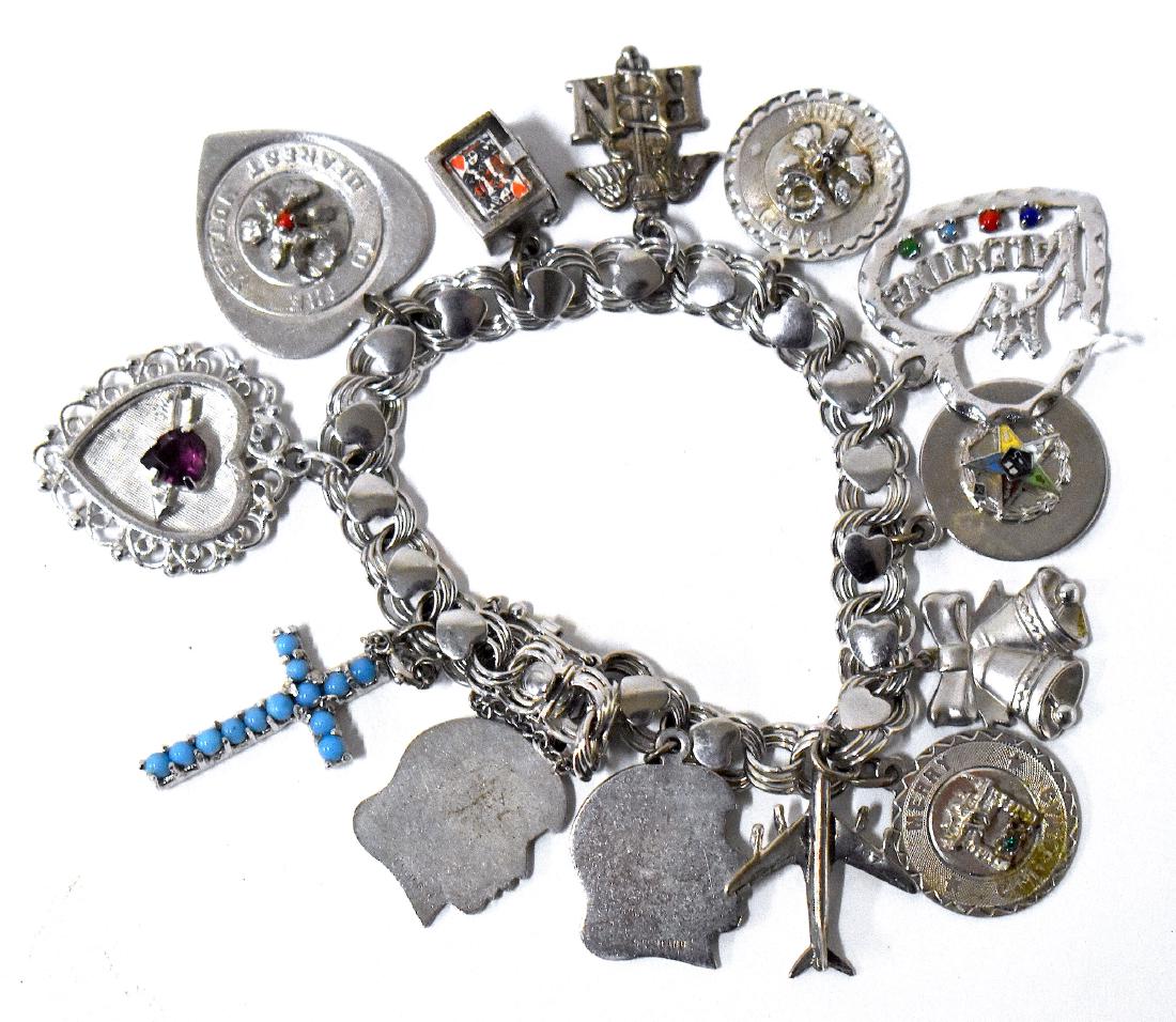 Sterling Silver Charm Bracelet with 12 Charms.: 1.66 troy ounces.