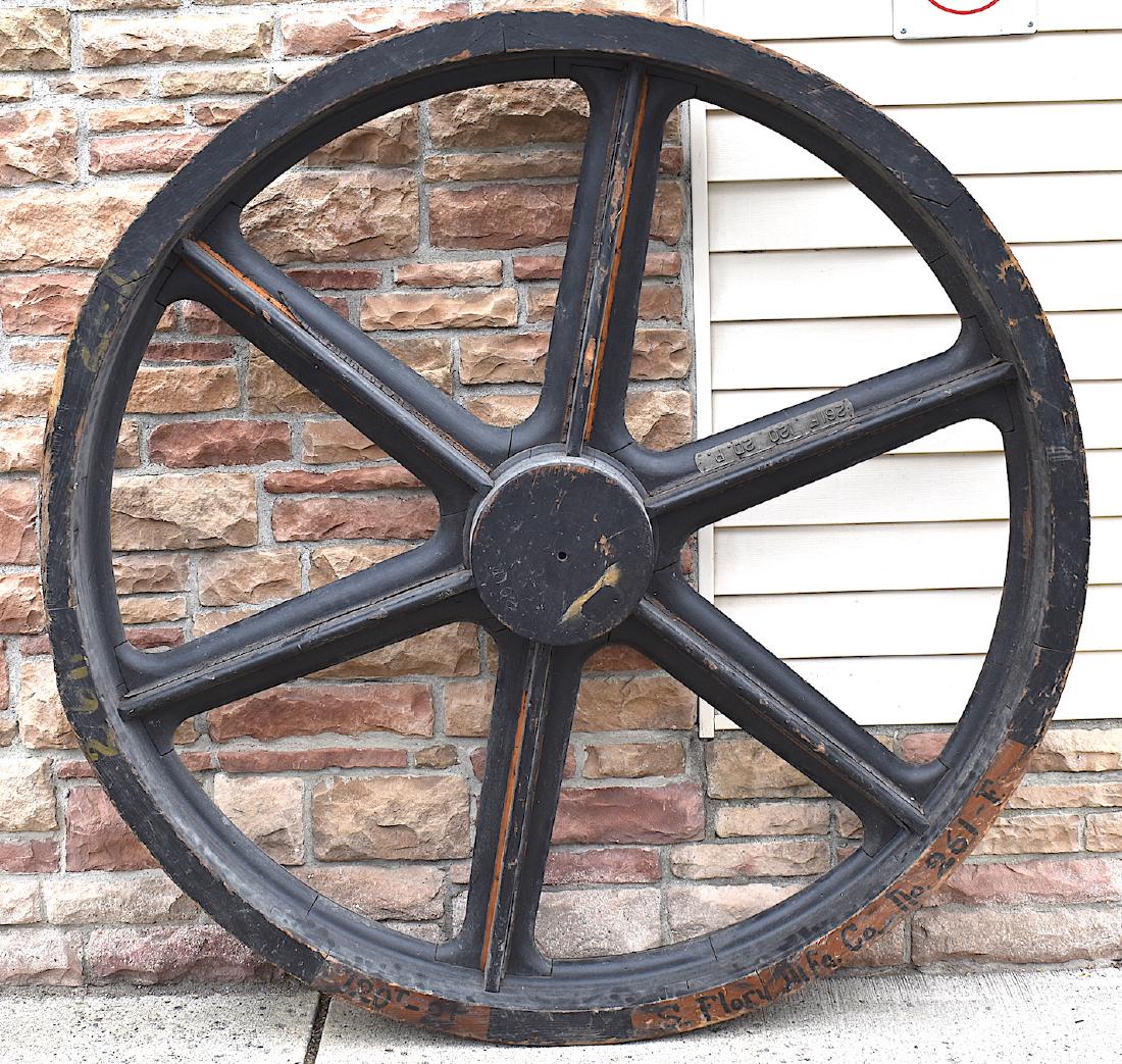 Antique Casting Wheel. Oversized. S. Flory Mfg. Co.: Would fit perfectly in n a commercial or industrial setting. Reads S. FLory Mfg Co. No. 261-F. Aprox 63" Diamter 9" Wide.