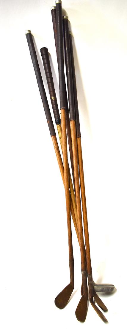 Lot of Wood Handled Vintage Golf Clubs (6): One 3 Iron marked MacGregor, Dayton .O. Four are marked Burke Sportsmen. Matched Irons. Size vary 30"Tall-37"Tall.