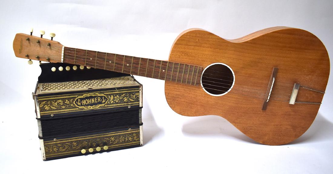 Vintage Hohner Organetto & Vintage Guitar: Vintage Hohner German Organetto and a vintage Riviera guitar. 9"H. x 12"W. x 6"D (acordion) and 35"L. x 13 1/2"W (guitar)