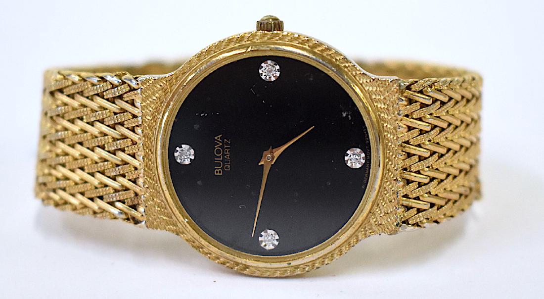 Bulova Quartz Watch. Gold Mesh Band: Black face with simulated quarter hour diamonds. Marked Bulova Watch Co.