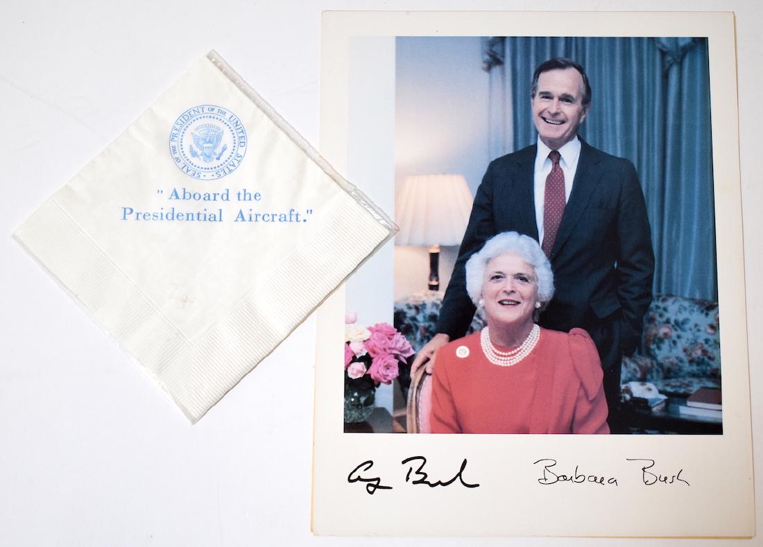 Air Force One Presidential Napkin: With the President of the United States Seal. Printed "Aboard the Presidential Aircraft" With a photo of George and Barbara Bush with printed signature. Photo is 8 x 10 and napkin is 5" x 5"