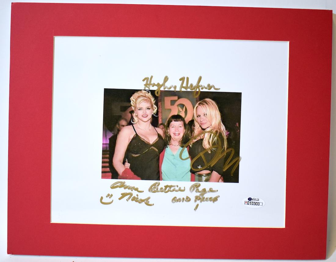 Photograph Sgd. by Hugh Hefner. Bettie Page, Anna: At a "50th" Celebration, a photograph signed by Anna Nichol with a smiley face; sgd. by Bettie Page (a rarity_ and Loni Anderson in 2003-2004. Matted size is 11" x 14"