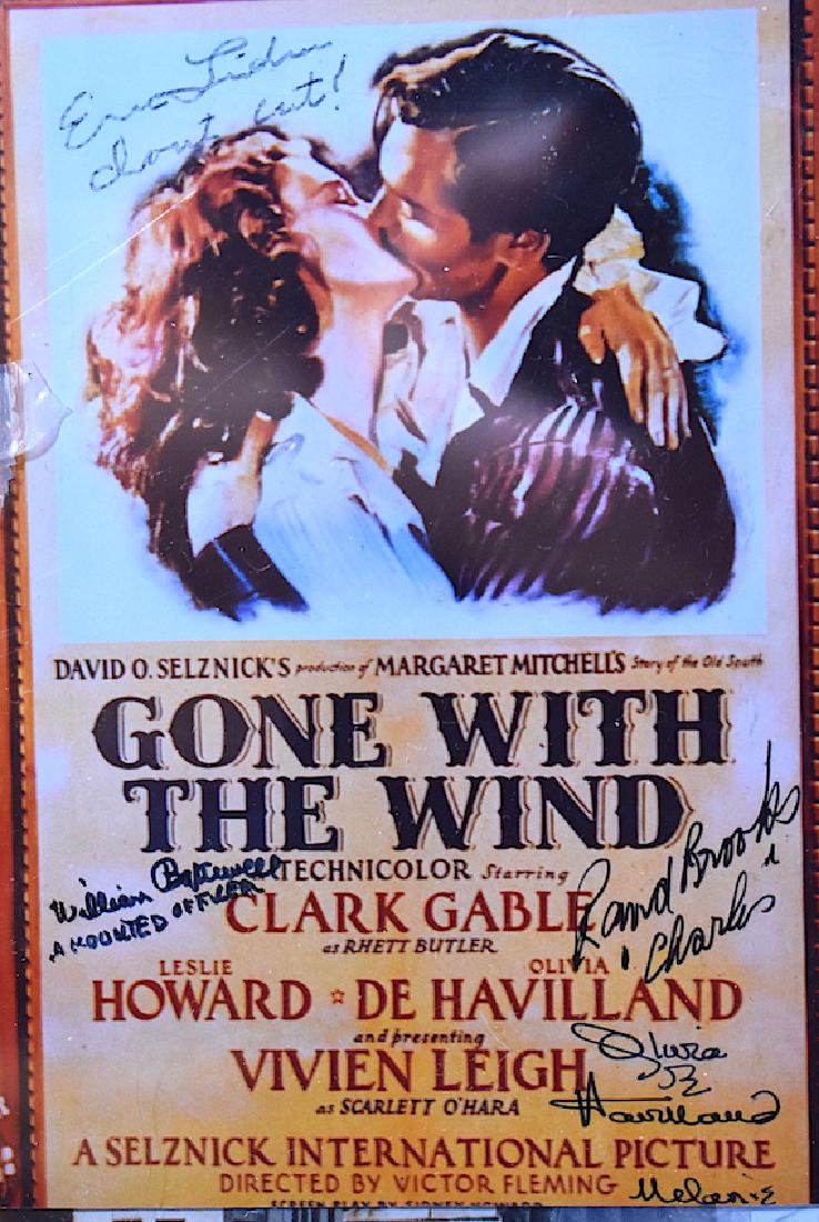 Olivia DeHavilland Autograph & Others. GWTW: ink signatures on a Gone with the Wind Poster photo by (four signatures) Olivia DeHavilland; Eric Linden; Rand Brooks; William Blackwell all in ink or Sharpee. With a Certificate of Authenticity from