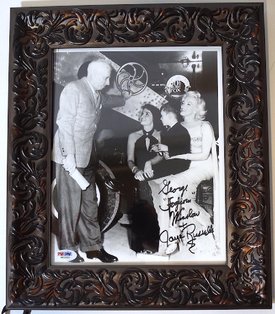 Autographed Jane Russell Photo with Marilyn: Jane Russell with Marilyn Monroe on the set of 20th C. Fox. Signed in Black Sharpee George Foglion Winslow. Jane Russell. in an ornate gessoed frame. 8 x 10 photo.