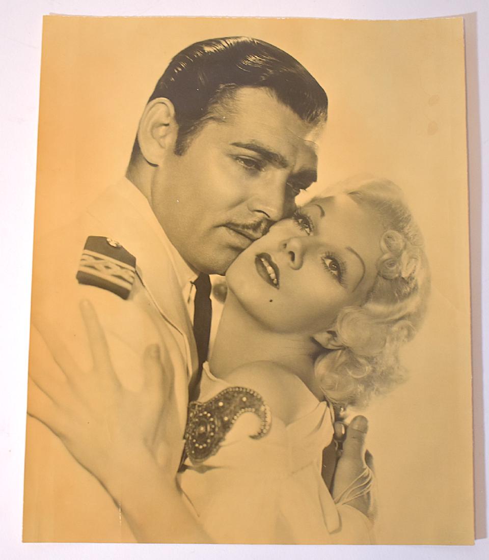 Clarence S. Bull Photo Gable and Harlow: Clark Gable and Jean Harlow publicity photo for MGM with a foreign language publicity snipe at the back for "Mares de China". Multiple other stamps for Film Fotos, Clarence Bull and Mundo Grafica More