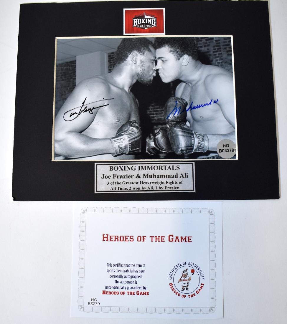 Joe Frasier Muhammed Ali Autographed Photo: Signed in blue ink. With certificate of authenticity. Photo is 7 1/4" x 5" and overall size is 8" x 10"