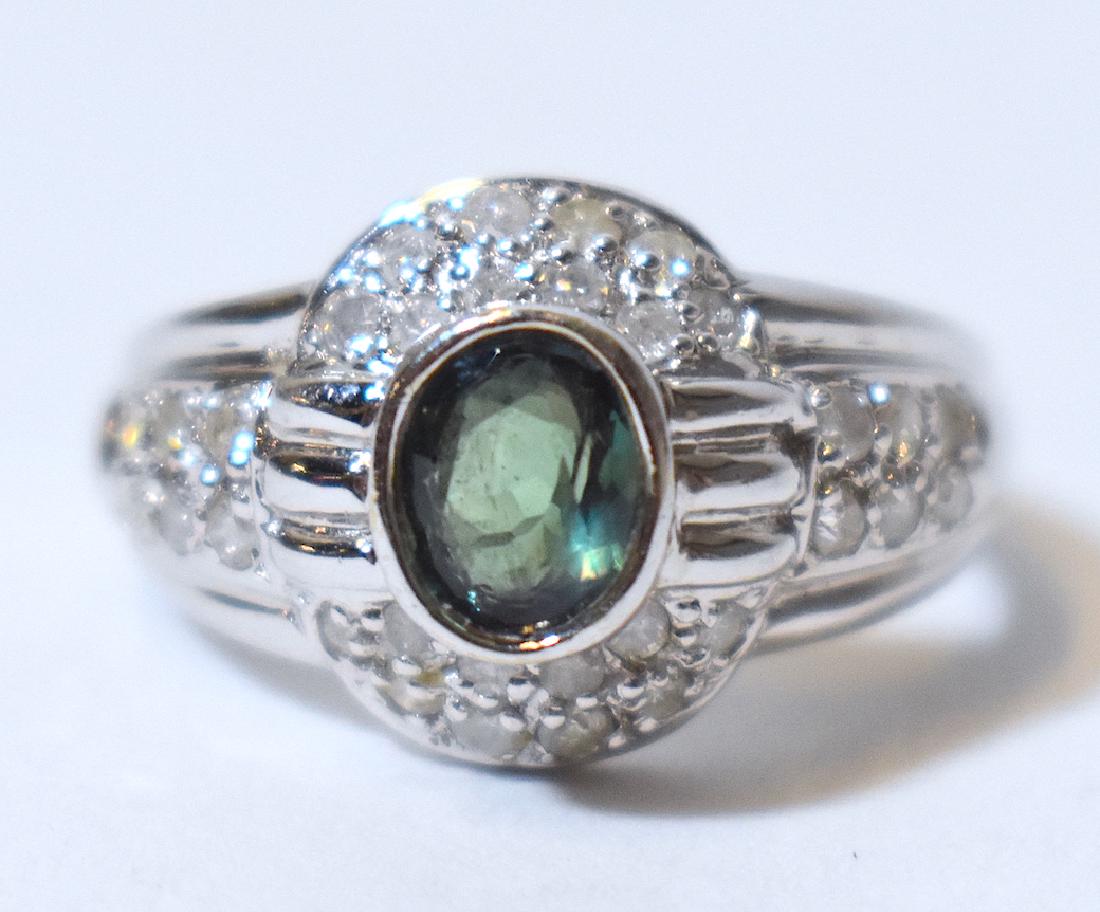 Alexandrite and Diamond Ring. 14KWG: ,73 Carat Alexandrite and .26 carate diamond surround in a 14K White Gold Setting
