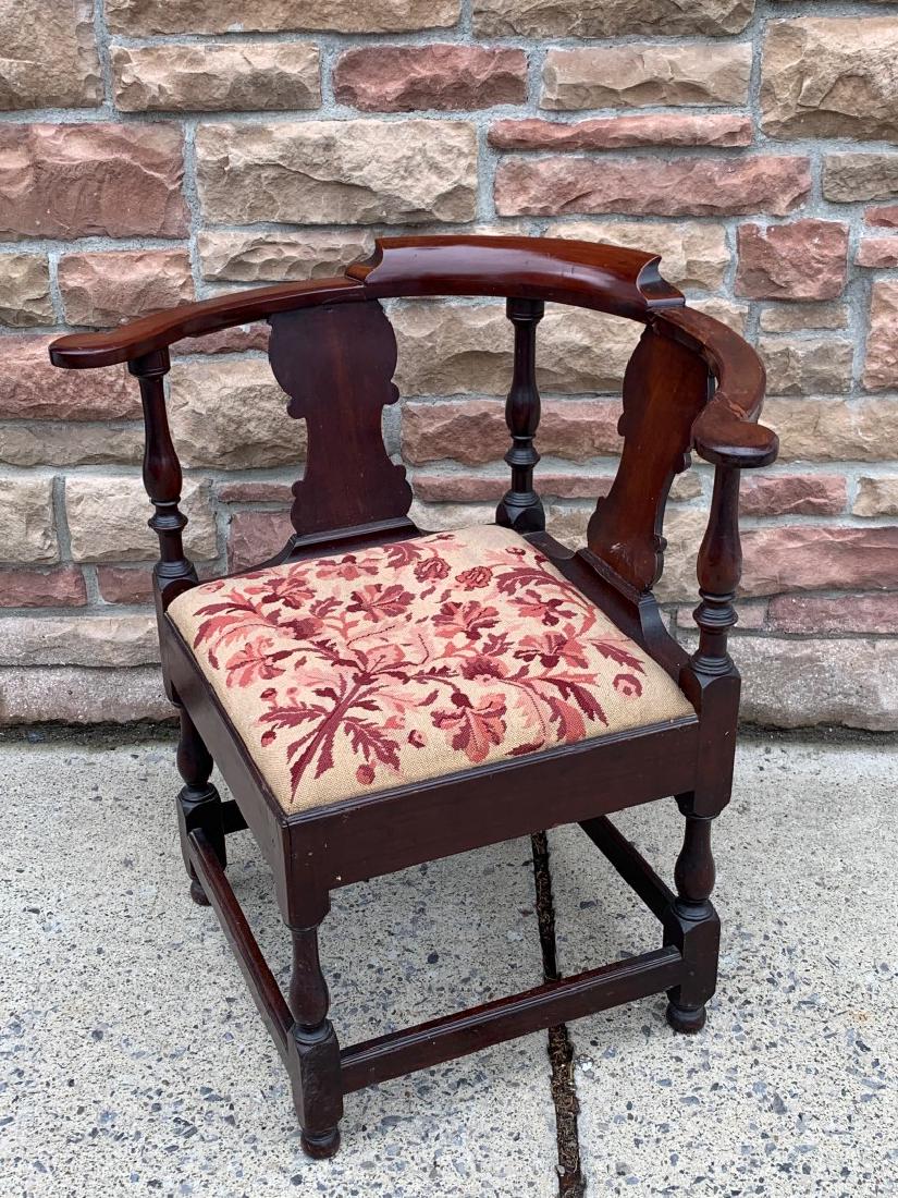 Victorian Upholstered Mahogany Corner Chair: Carved mahogany corner chair. Needlepoint upholstered seat; 31in.H. x 24in.W.