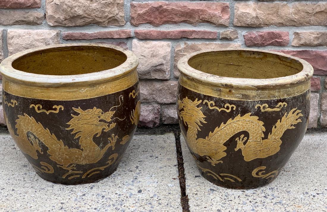 Pair of 19thC. Chinese Earthenware Planters: Pair of glazed earthenware planters. Dragon decoration; 16in.H. x 17in.D.