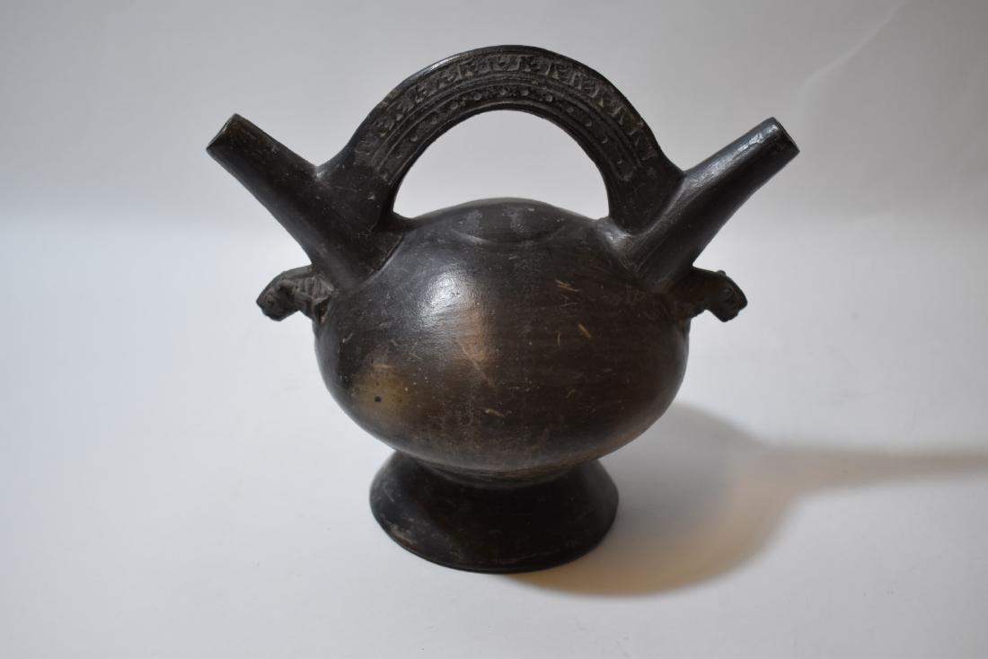 Early Pre-Columbian Inca Pottery Vessel: Very early Inca black pottery vessel. Lambayeque style double-spouted blackware stirrup vessel having carved animal heads and decorated handle. Aquired by the past owner, J.L. Worthington circa 1953. 