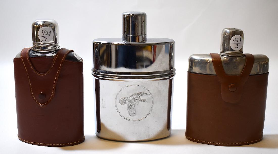 Three Flasks, German, English & Wild Turkey: Two leather cased flasks, one English, one German and a Wild Turkey Kentucky Straight Bourbon Whiskey Chrome flask with advertising symbol at the front. Varying sizes. 7 inches H. (Wild Turkey) to 5 i