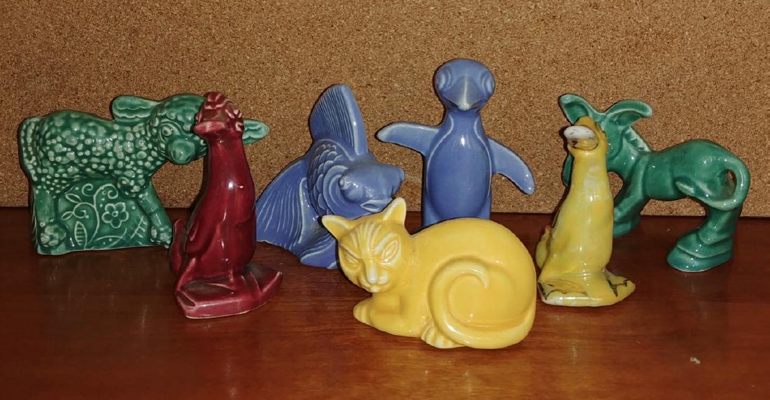Homer Laughlin Animal Figures (7): Green Lamb; Yellow Cat; Blue Fish; Green Donkey; Blue Penguin; Red Duck; Yellow Duck with gilt decorations. Fish measures 3-7/8" L x 2-3/4" H