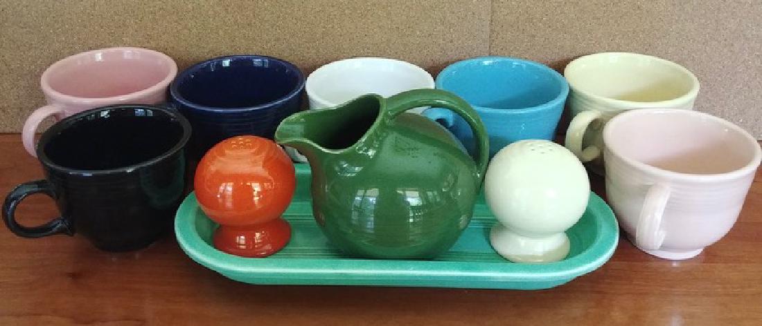Fiestaware Lot, Plates, Cups, etc. (19): Nineteen pieces of Fiestaware including dinner plates, 7 cups, salt & pepper, green oval tray and a cream pitcher. Varying sizes - Oblong tray is 10-1/4" long