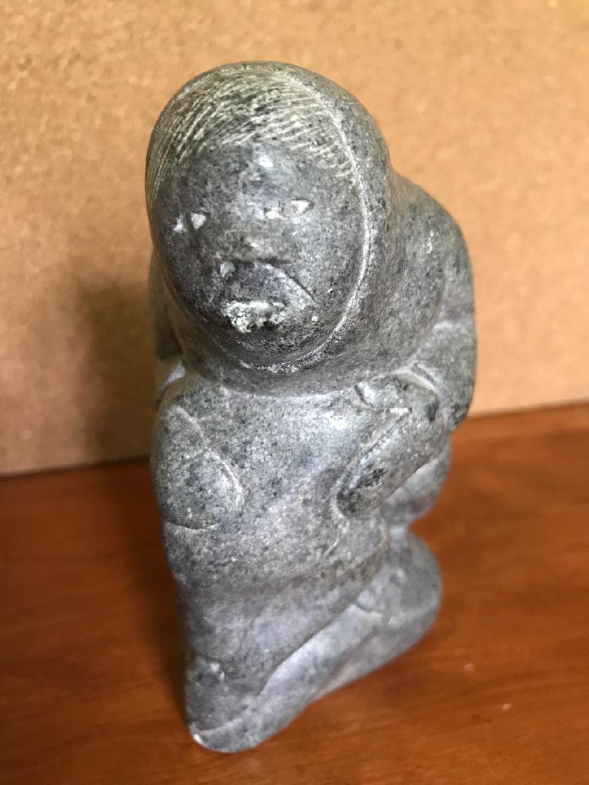 Vintage Inuit Eskimo Art Soapstone Carving: Man and a Seal. Label reads Eskimo Art Esquimau. Signed and numbered at the base. 5-3/8" High