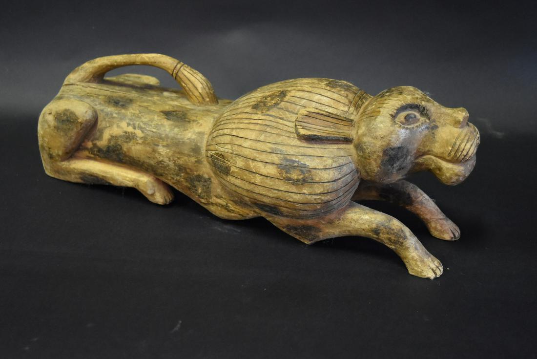 Indonesian Carved and Incised Wood Lion: Carved wood reclining lion. Incised and burnished decoration; 6.5in.H. x 20in.L. x 7in.W.